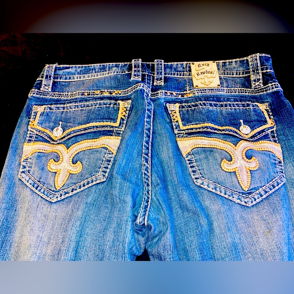 Mens Rock Revival Jeans. Size 42. Color blue with silver/orange stitching